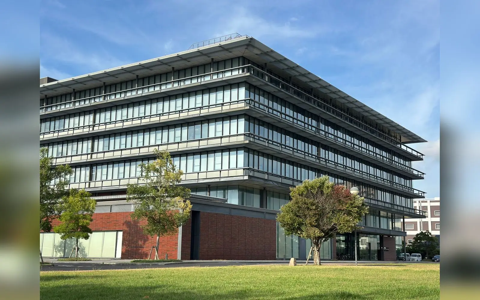 Photo of a modern multi-storey commercial building with landscaping