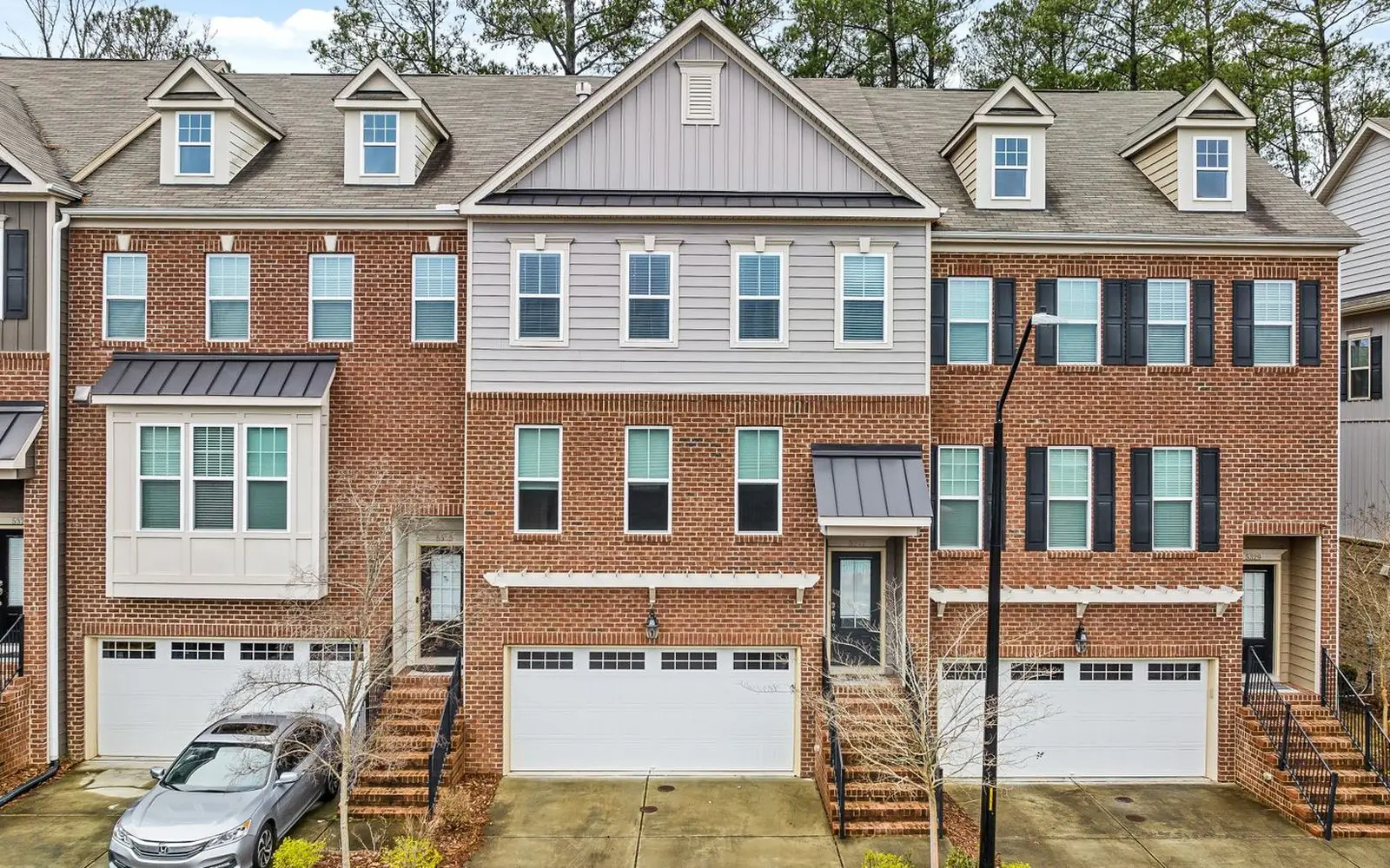 A row of brick townhouses with garages