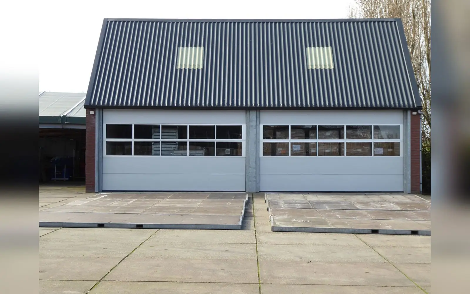 An industrial building with roller doors and a metal roof