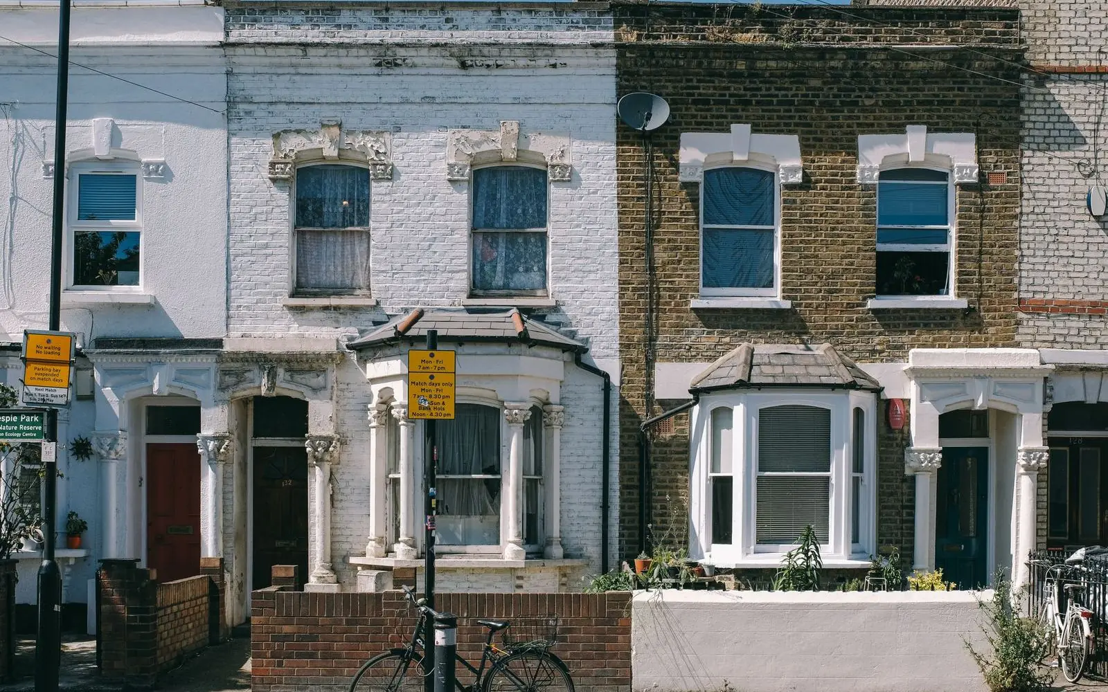 Neighbouring terraced houses side by side on a street