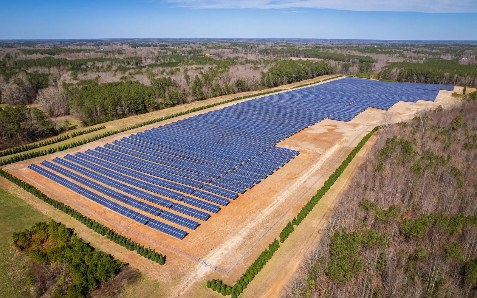 Aerial view of a solar farm cleared into bush
