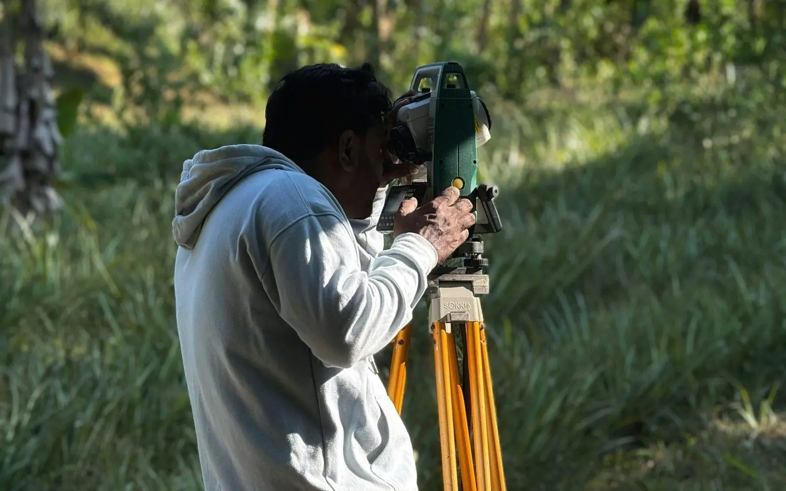 Surveyor setting up a total station