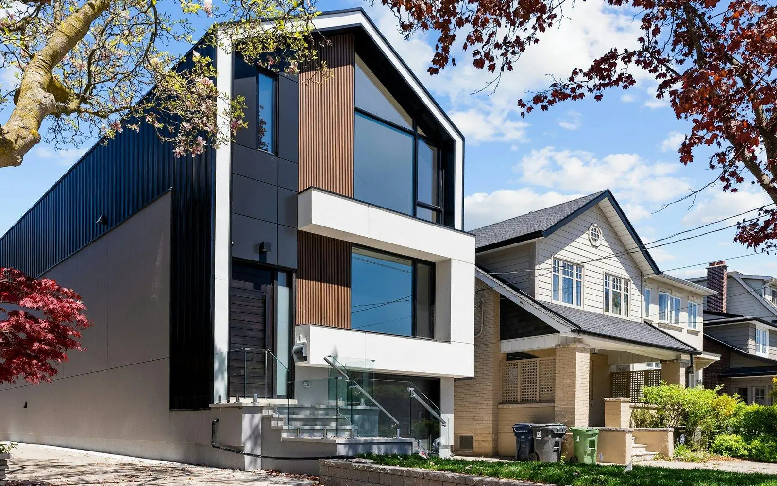 A new modern house beside a traditional home